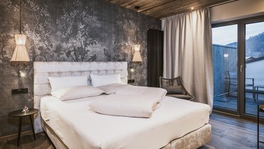 Panorama Restaurant Hotel Margarethenstein gemütliches Bett in der Auszeit Suite im Design Hotel Margarethenstein