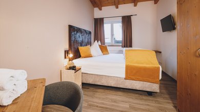 Bett im Apartment mit eigener Sauna im Margarethenstein 