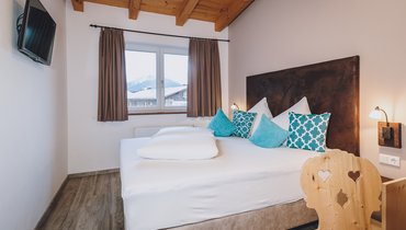Bett im Apartment Typ B mit eigener Sauna im Margarethenstein